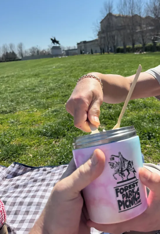 Couple sharing a Forest Park Picnics ice cream pint at Art Hill in Forest Park, St. Louis